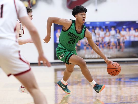 Eli Pickens gets past a Leopard defender and moves the ball into position for Burnet. The Dawgs came up short in Bi-District play, 54-48 ending their 2024-25 season. Photo by Wayne Craig/Clear Memories