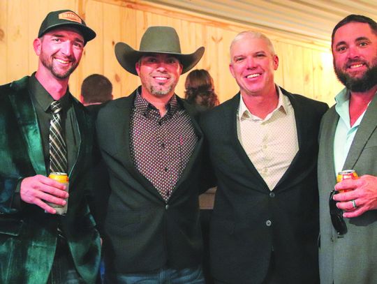 Kellen Floyd, James Parks, Bobby Crawford, and Ian Woods paused Feb. 8 for a photo during the Masquerade Gala to encourage contributions.