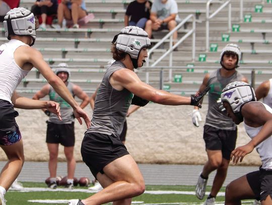 Burnet receiver Cason O’Hair instinctively puts a hand out to create space between himself and the Marble Falls defenders.