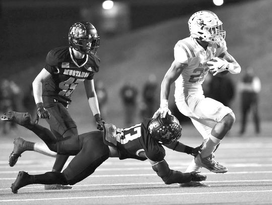 Bulldog RB Josiah Coronado uses an effective stiff arm on a Mustang before busting loose for Burnet’s first score of the game. Coronado scored twice during Burnet’s Bi-District match versus Andrews.