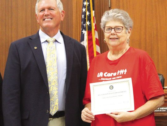 Raymond V. Whelan/Bulletin The Burnet County Commissioners Court recently congratulated the Lakes Area Food Pantry (LACare) for 40 years of service. LACare Executive Director Lottie McCorkle is pictured with Burnet County Judge Bryan Wilson.
