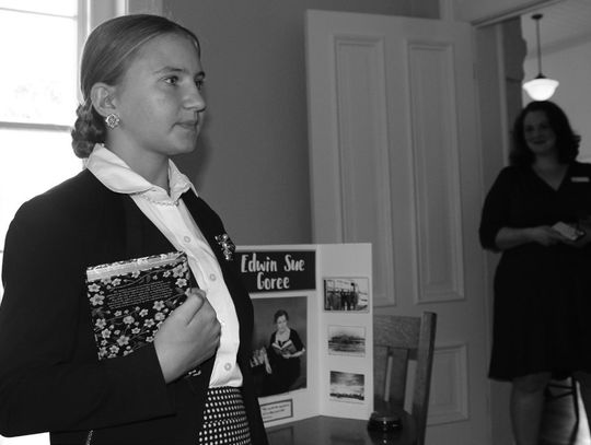 Burnet Home School student Sara Beth Nichols, 13, portrayed Edwin Sue Goree (pictured behind Nichols), the first Burnet Library Director 75 years ago, while current Herman Brown Free Library Director Florence Reeves observes. Photos by Raymond V. Whelan/Bulletin