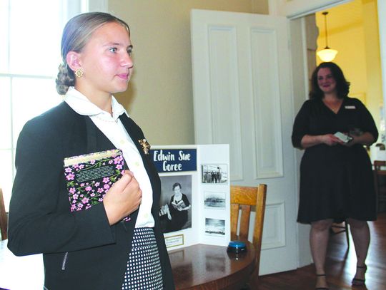 Burnet Home School student Sara Beth Nichols, 13, portrayed Edwin Sue Goree (pictured behind Nichols), the first Burnet Library Director 75 years ago, while current Herman Brown Free Library Director Florence Reeves observes. Photos by Raymond V. Whelan/Bulletin
