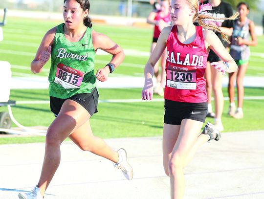 Varsity Lady Bulldog, Abby Bennight, battles a Salado runner in the final 100 yards of Tuesday district cross country races in Marble Falls. Bennight won the battle and finished eighth individually to lead her team who finished second in district. Photos by Wayne Craig/Clear Memories