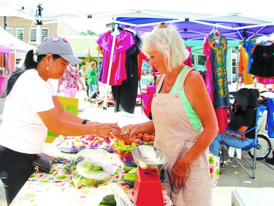 Millie Moneymaker bought vegetables from Mary Wood June 15 at the Farmers Market on the square in Burnet. Photos by Martelle Luedecke/Luedecke Photography