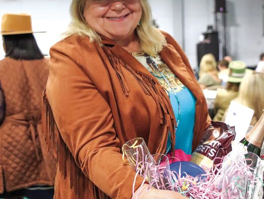A happy Cheri Trinidad emerged as a big winner at the Highland Lakes Service League Chuck Wagon Chow Down Jan. 25 at the YMCA.