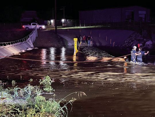 Crew saves motorist at flooded crossing
