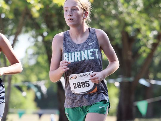 Pictured above Savannah Griffin battles for position during a two-mile varsity race. The Lady Dawgs competed against 369 runners at Friday’s McNeil Invitational.