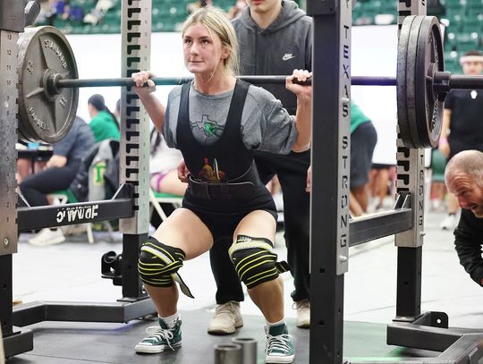 Josie Teague carefully descends into her 315 squat at Friday’s regional meet. Teague placed second earning a spot at state. Photo by Wayne Craig/Clear Memories