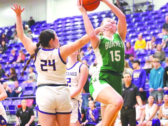 Senior Aubrey Mathews finds a way to make her shot through contact and earns a free-throw shot during the Lady Dawgs win over Marble Falls. Photos by Wayne Craig/Clear Memories