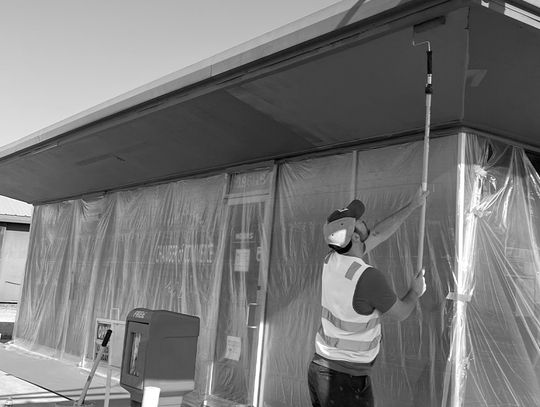 LCRA employee Chase Rushing paints the exterior of the Lake Buchanan/Inks Lake Chamber of Commerce &amp; Visitor Center during LCRA’s Steps Forward Day on April 11. Contributed photo