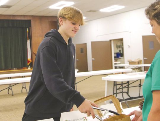 Michael Dean placed a cookie in Monica Burton’s box during the Cookie Walk to support Burnet County 4-H at AgriLife auditorium. Find more photos Inside. Martelle Luedecke/Luedecke Photography