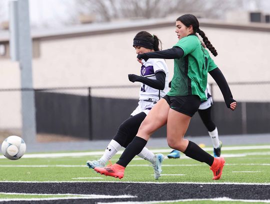 Pictured above Bella Medina successfully boots one of her two goals against Florence. The Lady Dawg soccer team clinched a playoff spot with their Tuesday win over Northeast Early College and are 13-0 in district. Photo by Wayne Craig/Clear Memories