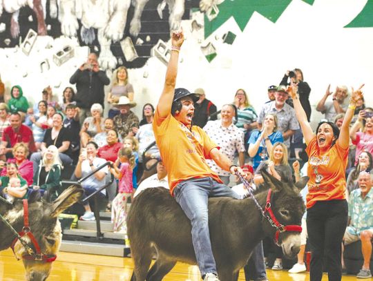 Fueled by cheers from Kelsey Werner, Marcus Pimentel rode his donkey across the finish line during Donkey Basketball on April 17 at Burnet Middle School, an event supporting Project Graduation 2025. Allison Morrow/ Luedecke Photography 