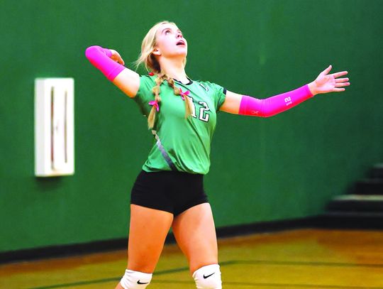 During Tuesday’s Pink Out match versus Marble Falls freshman Maycee Floyd (12) focuses on the ball at the service line.