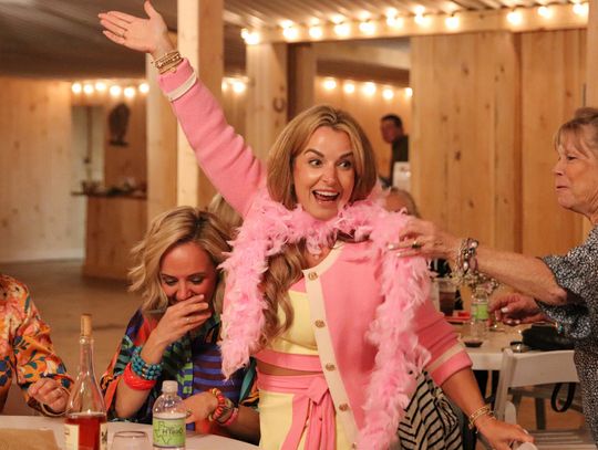 Photos by Martelle Luedecke/Luedecke Photography Casey Current temporarily wore a pink boa Bunco winner prize Feb. 26 during Bunco for Babies at Wagon Springs Ranch.