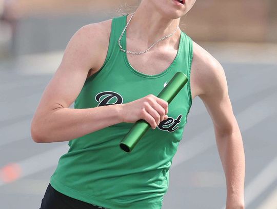 Varsity Lady Bulldog, Kalora Mcdonnell swiftly moves around the track in her anchor leg position for the 800 meter relay team. Photos by Wayne Craig/Clear Memories