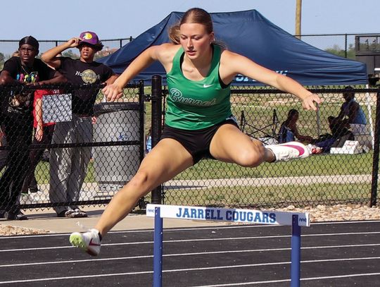 Above, junior hurdler Wrigley Mulhollan made sure to set a new personal record at the area meet. Photos by Martelle Luedecke/Luedecke Photography