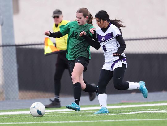 Varsity Lady Bulldog soccer athlete, Avery Barth, battles a Florence defender before providing a teammate an assist during Friday’s game in Burnet. Photo by Wayne Craig/Clear Memories