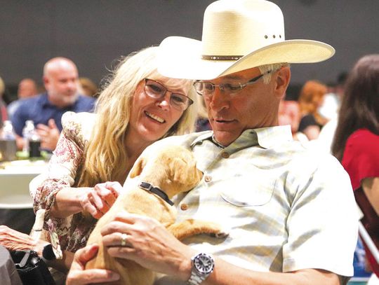 Kathy and Alan Trevino, owner of event title sponsor Sentry Security & Investigations, were charmed by Scotty on April 26 at the Wags to Riches, which raised money for the Hill Country Humane Society. Find more photos on Page 14.