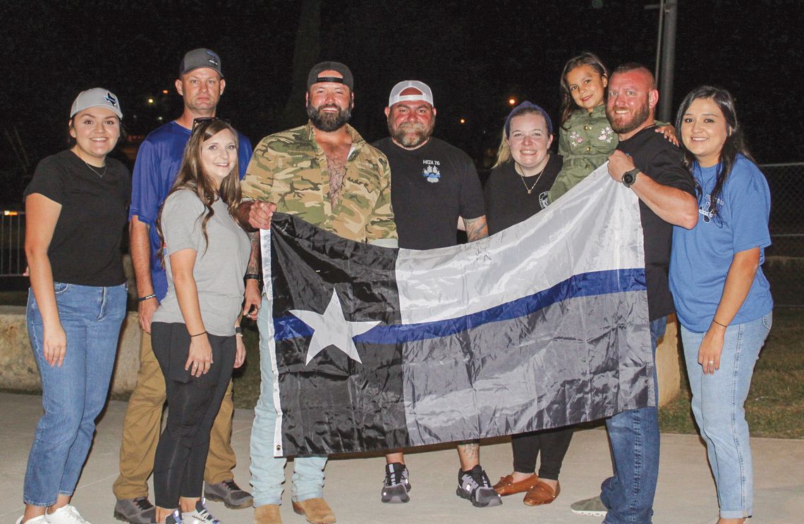 Backing the Blue During Project 316, Bailey Rodgers, Jeremy Stewart, Tiffany Clark, Mike Ryan, Mia Meza (daughter of the late Burnet Police Officer Jose Meza), Jason Coates, Mariela Silva, and Carla Meadows held a blue-line Texas flag for their photo Saturday Oct. 5 at Haley Nelson Park. Find more photos o...
