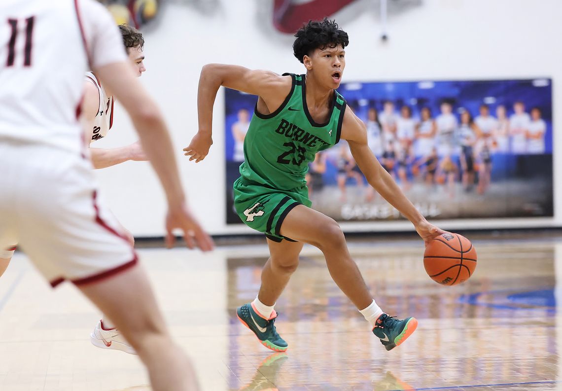 Eli Pickens gets past a Leopard defender and moves the ball into position for Burnet. The Dawgs came up short in Bi-District play, 54-48 ending their 2024-25 season. Photo by Wayne Craig/Clear Memories