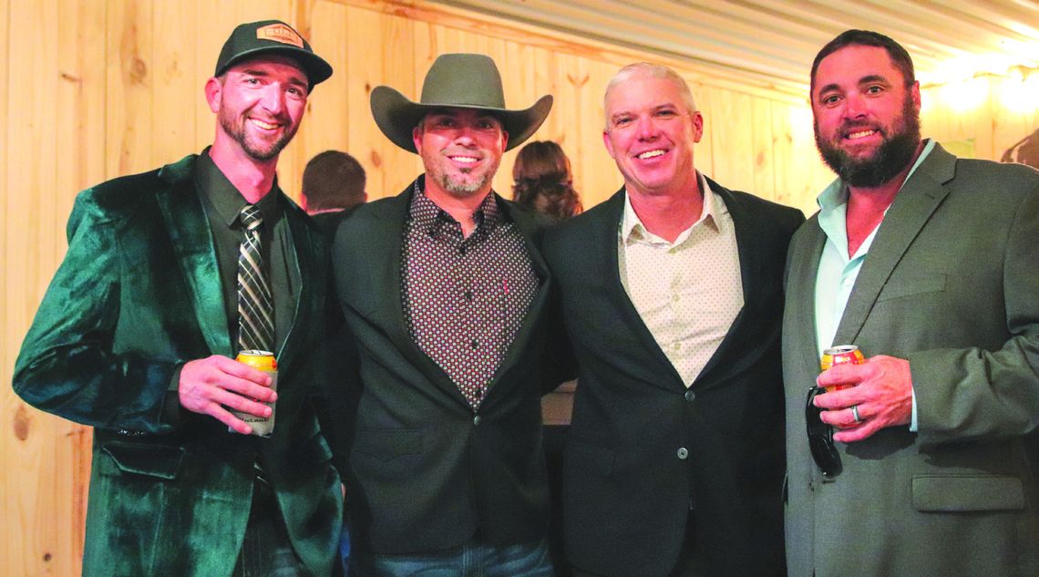 Kellen Floyd, James Parks, Bobby Crawford, and Ian Woods paused Feb. 8 for a photo during the Masquerade Gala to encourage contributions.