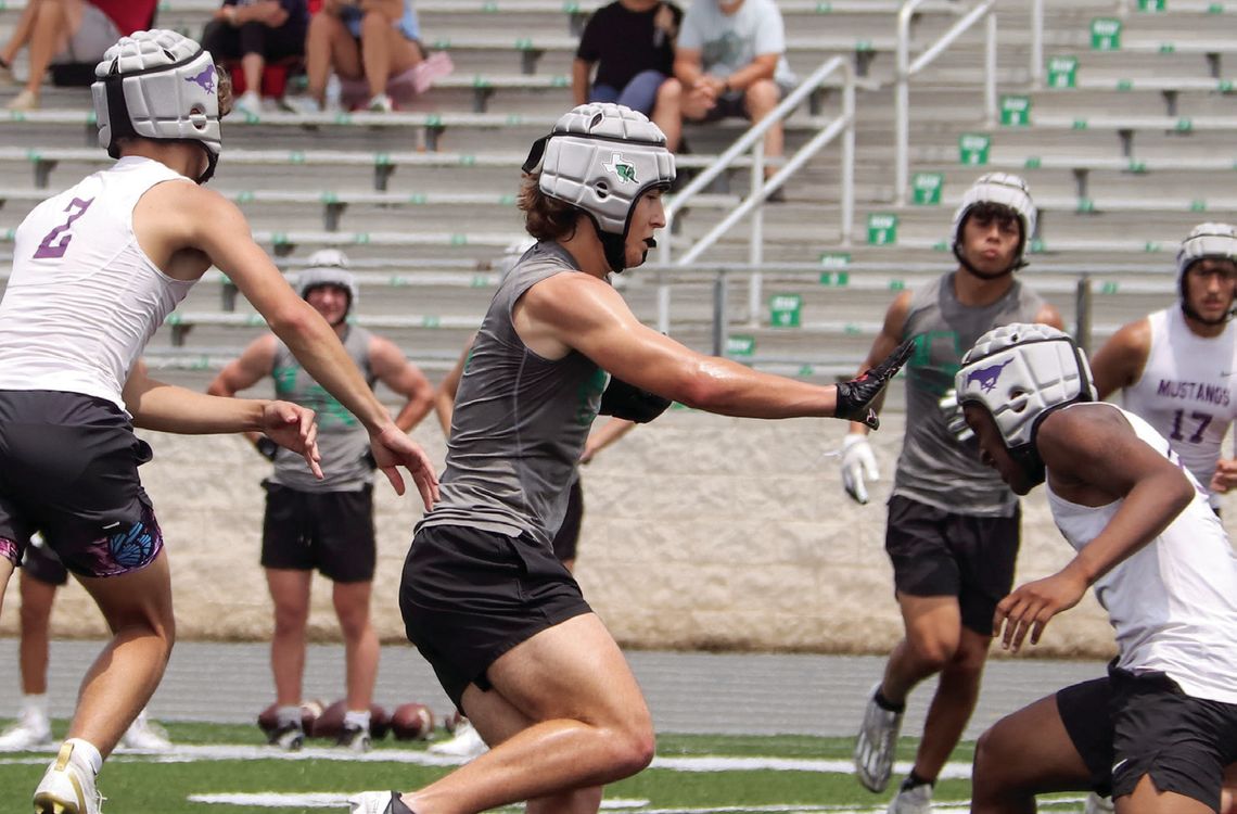 Burnet receiver Cason O’Hair instinctively puts a hand out to create space between himself and the Marble Falls defenders.