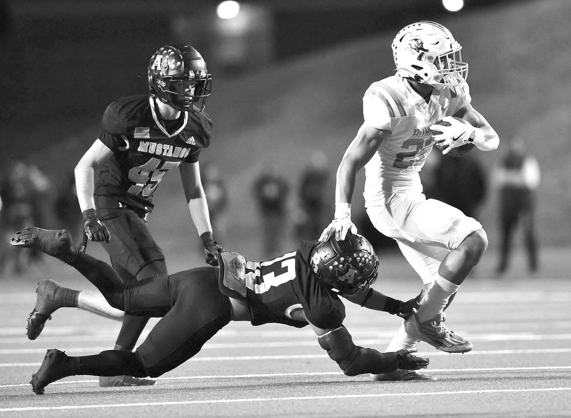 Bulldog RB Josiah Coronado uses an effective stiff arm on a Mustang before busting loose for Burnet’s first score of the game. Coronado scored twice during Burnet’s Bi-District match versus Andrews.