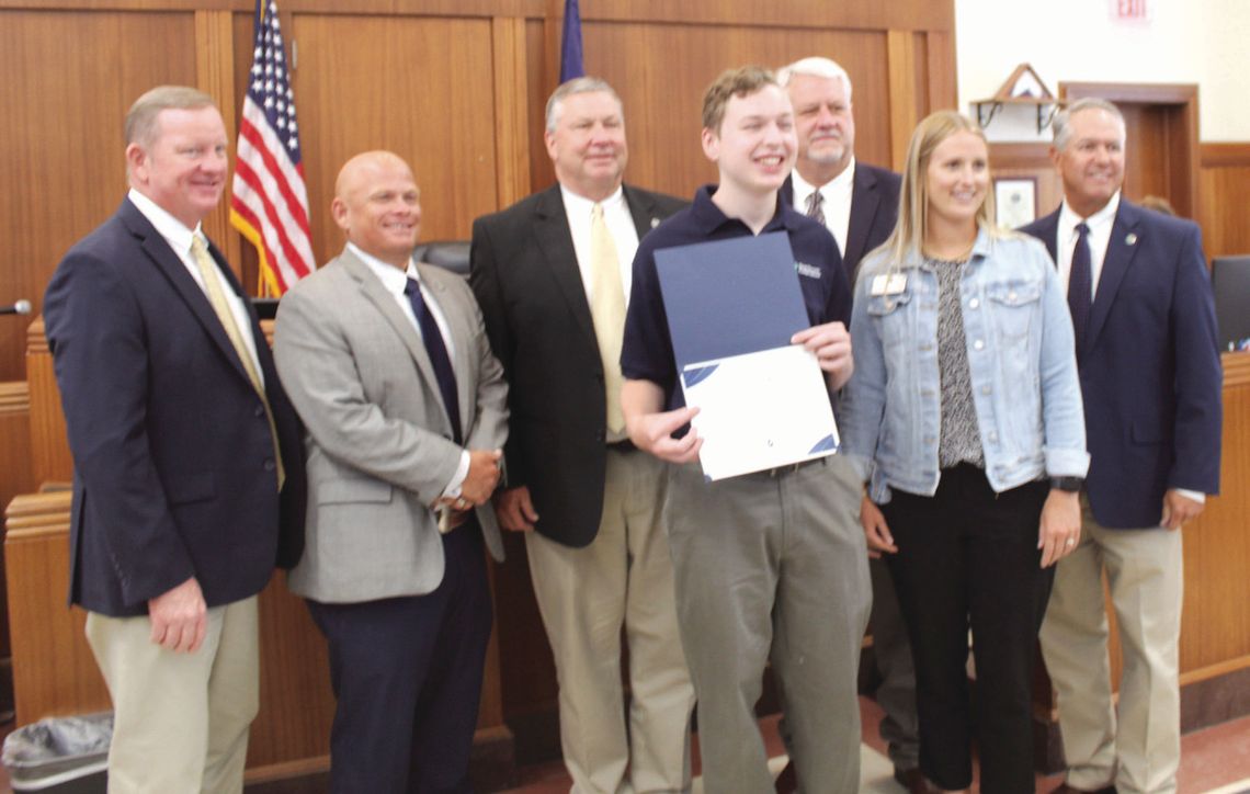The Burnet County commissioners acknowledge Marble Falls High School senior Henry Vanicek as he holds the Pedernales Electric Cooperative Certificate of Appreciation for his participation in the 2024 Youth Tour Delegates Program. From left, Pct. 1 Commissioner Jim Luther Jr., Pct. 2 Damon...