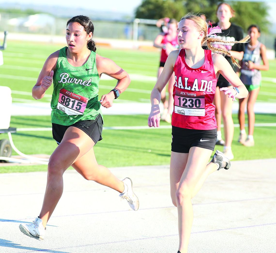 Varsity Lady Bulldog, Abby Bennight, battles a Salado runner in the final 100 yards of Tuesday district cross country races in Marble Falls. Bennight won the battle and finished eighth individually to lead her team who finished second in district. Photos by Wayne Craig/Clear Memories