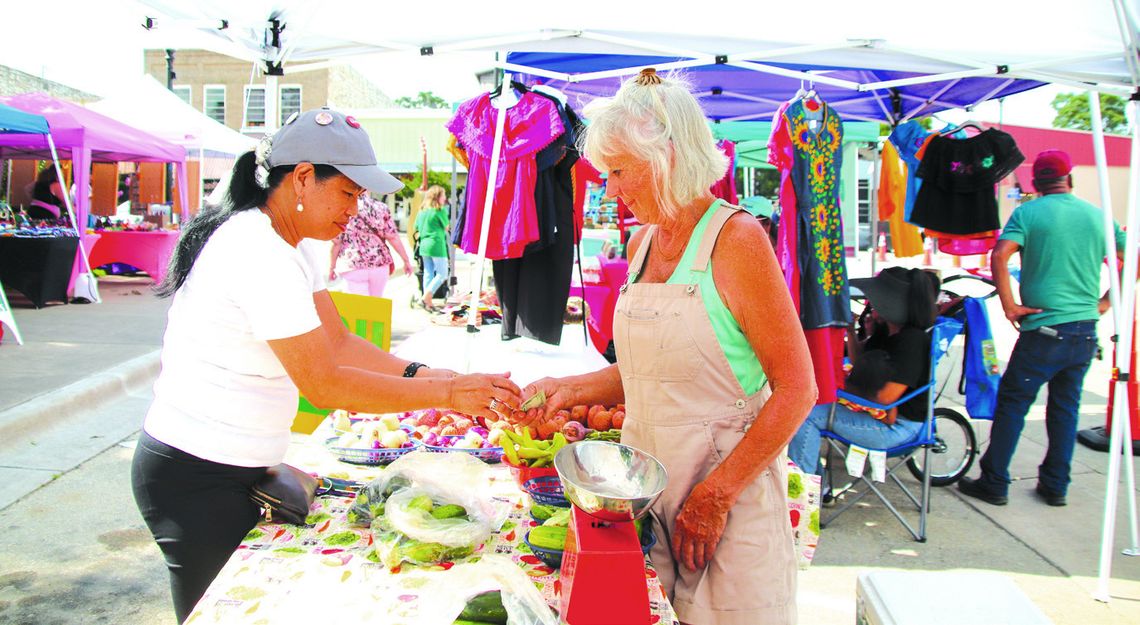 Millie Moneymaker bought vegetables from Mary Wood June 15 at the Farmers Market on the square in Burnet. Photos by Martelle Luedecke/Luedecke Photography