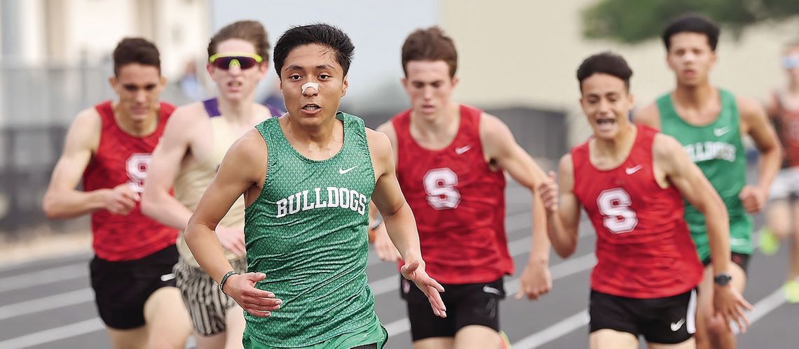Chasing victory: Burnet senior distance runner Victor Aviles earned three gold medals at Wednesday’s district meet in the 3200, 1600, and 800. Above Aviles leads a pack as he crosses the 3200 finish line for first. Photos by Wayne Craig/Clear Memories