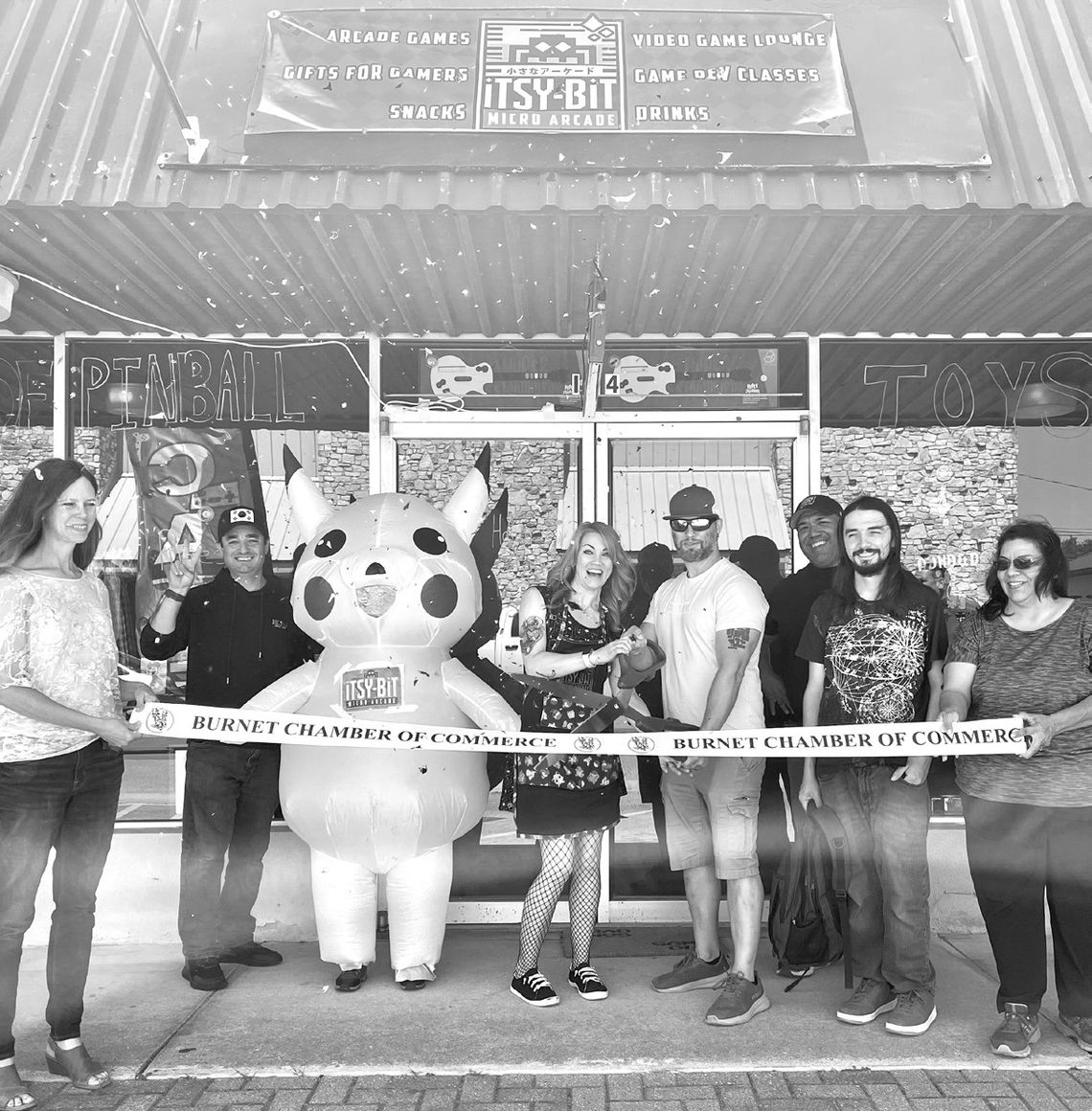 From left, Burnet Chamber Executive Director Allison McKee, Juan Medina, ‘Pikachu’, owners Mandy and Blake Lowry, David Ramon, Dale Nuttall and Gloria Flores helped re-open the Itsy-Bit Arcade May 8 at its new location on Burnet square,124 S Main St. Contributed photos