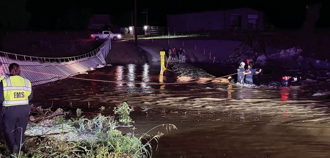 Crew saves motorist at flooded crossing