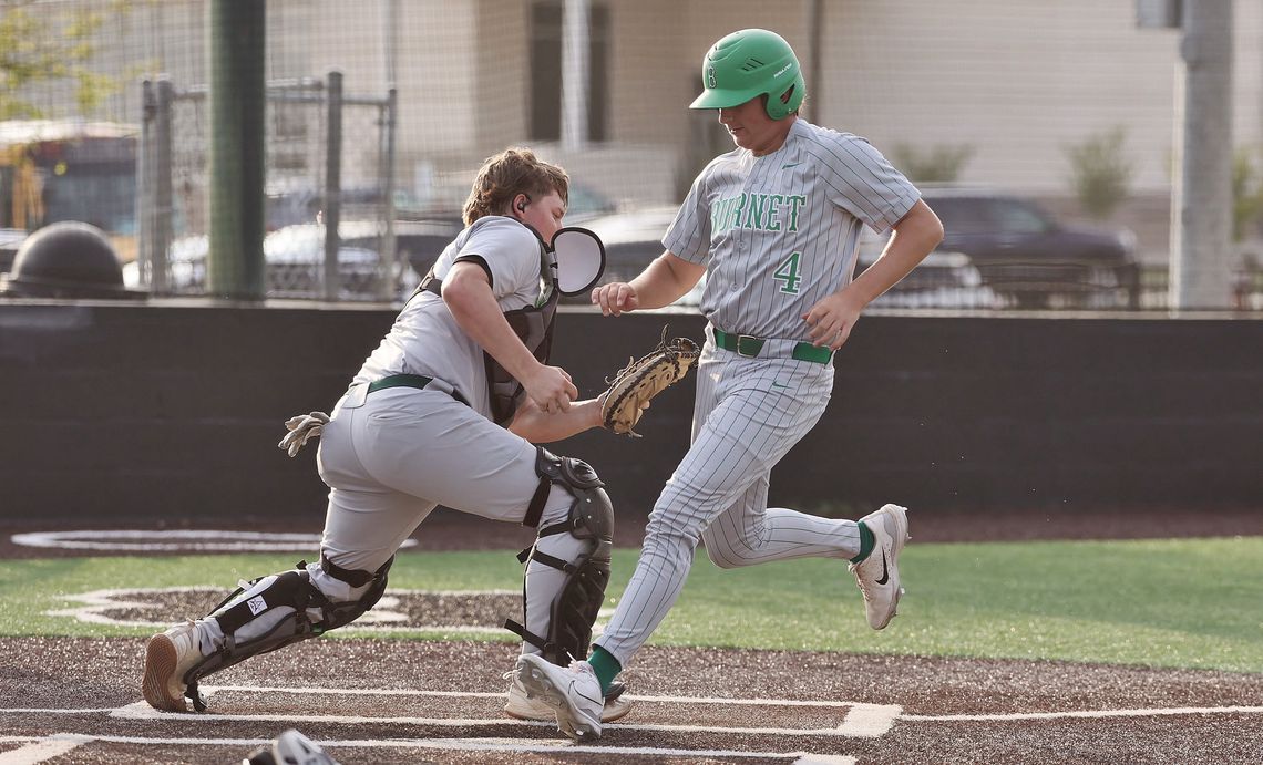Trey Morrow steps on home for a Bulldog run to make it 3-1 on Friday versus Taylor. The play was close, but the Ducks catcher tagged with the glove while the ball rested in his other hand. Photos by Wayne Craig/Clear Memories