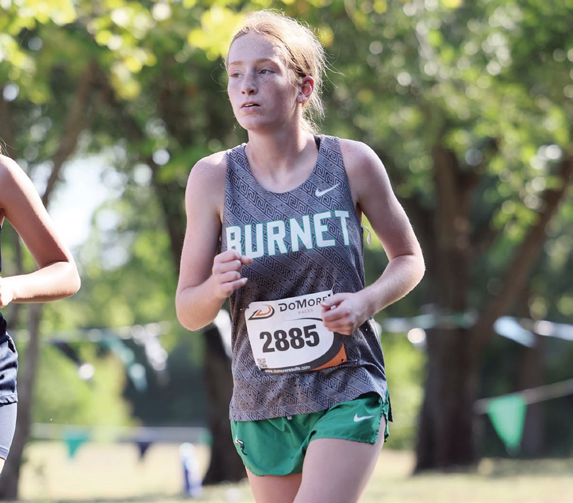 Pictured above Savannah Griffin battles for position during a two-mile varsity race. The Lady Dawgs competed against 369 runners at Friday’s McNeil Invitational.