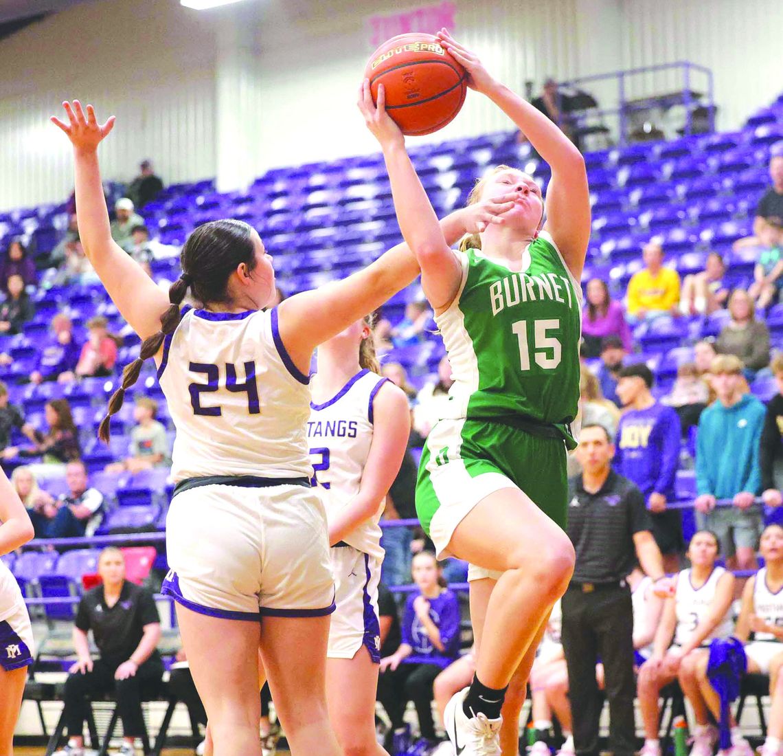 Senior Aubrey Mathews finds a way to make her shot through contact and earns a free-throw shot during the Lady Dawgs win over Marble Falls. Photos by Wayne Craig/Clear Memories