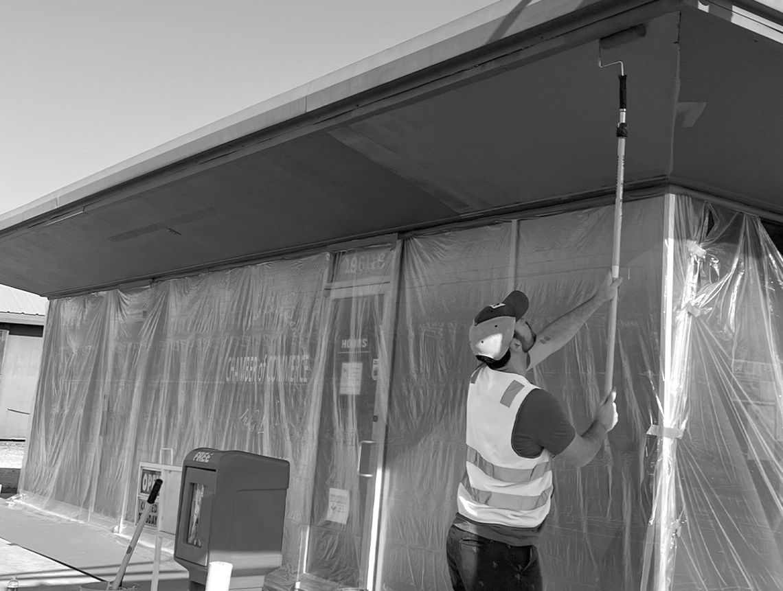 LCRA employee Chase Rushing paints the exterior of the Lake Buchanan/Inks Lake Chamber of Commerce &amp; Visitor Center during LCRA’s Steps Forward Day on April 11. Contributed photo