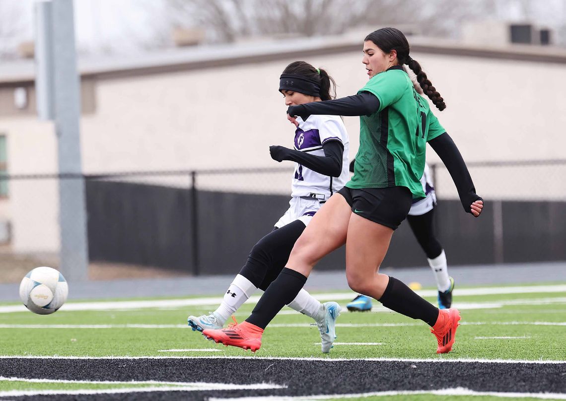 Pictured above Bella Medina successfully boots one of her two goals against Florence. The Lady Dawg soccer team clinched a playoff spot with their Tuesday win over Northeast Early College and are 13-0 in district. Photo by Wayne Craig/Clear Memories