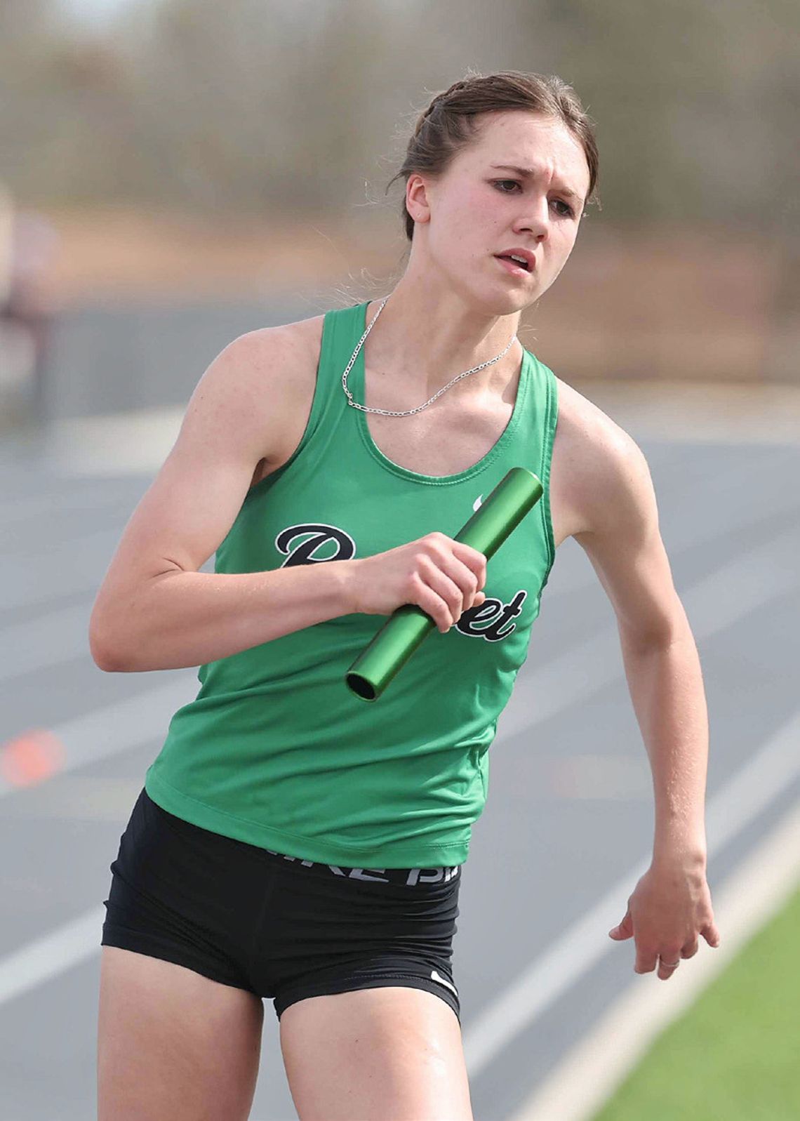 Varsity Lady Bulldog, Kalora Mcdonnell swiftly moves around the track in her anchor leg position for the 800 meter relay team. Photos by Wayne Craig/Clear Memories