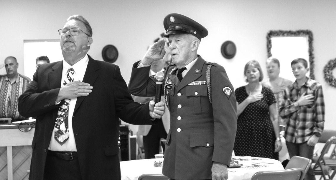 With his hand over his heart, Steve Leftwich held the microphone as veteran Steve Anderson stood tall and saluted the American flag, leading the crowd June 20 in the Pledge of Allegiance.