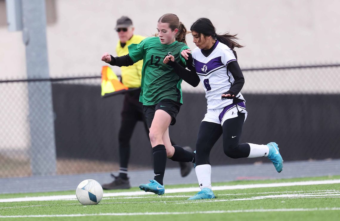 Varsity Lady Bulldog soccer athlete, Avery Barth, battles a Florence defender before providing a teammate an assist during Friday’s game in Burnet. Photo by Wayne Craig/Clear Memories